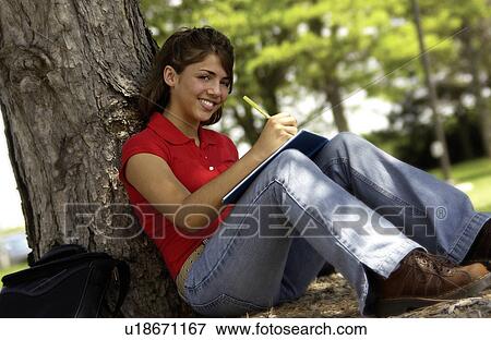 Girl studying under tree View Large Photo Image Stock Photo - Girl studying under tree. Fotosearch