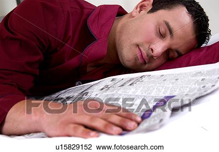 Stock Image - Hispanic man fell asleep while reading newspaper. Fotosearch