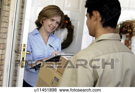 Man delivering package to home View Large Photo Image Stock Photo - Man delivering package to home. Fotosearch