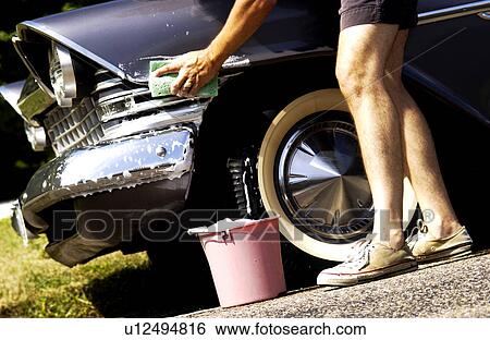 Stock Photograph - Man washing antique car. Fotosearch