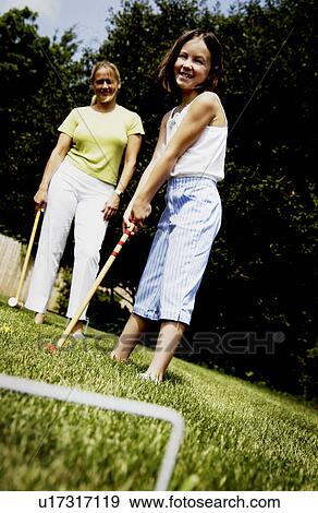 Stock Photo - Mom and daughter playing croquet. Fotosearch