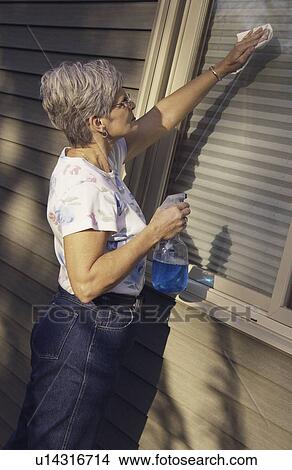 Senior woman cleaning window View Large Photo Image Picture - Senior woman cleaning window. Fotosearch