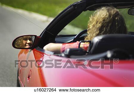 Picture - Woman driving convertible. Fotosearch