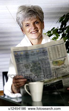 Woman reading newspaper View Large Photo Image Stock Photograph - Woman reading newspaper. Fotosearch