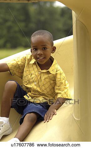African American boy on slide View Large Photo Image Stock Photograph - African American boy on slide. Fotosearch