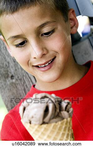 Boy eating ice cream cone View Large Photo Image Stock Photo - Boy eating ice cream cone. Fotosearch