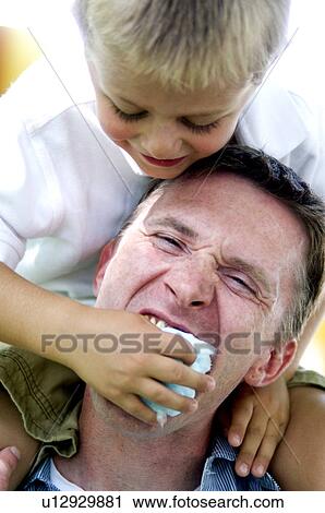 Boy feeding man cotton candy View Large Photo Image Stock Image - Boy feeding man cotton candy. Fotosearch