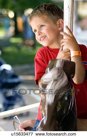 Boy on merry go round View Large Photo Image Stock Photo - Boy on merry go round. Fotosearch