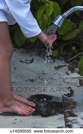Child rinsing sand off View Large Photo Image Stock Image - Child rinsing sand off. Fotosearch
