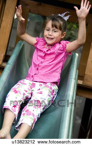 Girl going down slide View Large Photo Image Stock Image - Girl going down slide. Fotosearch
