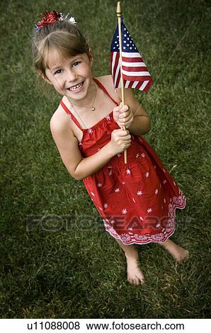 Stock Photo - Girl holding American Flag. Fotosearch