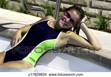 Girl lounging by pool View Large Photo Image Picture - Girl lounging by pool. Fotosearch
