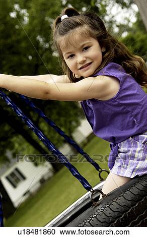 Girl on tire swing View Large Photo Image Stock Image - Girl on tire swing. Fotosearch