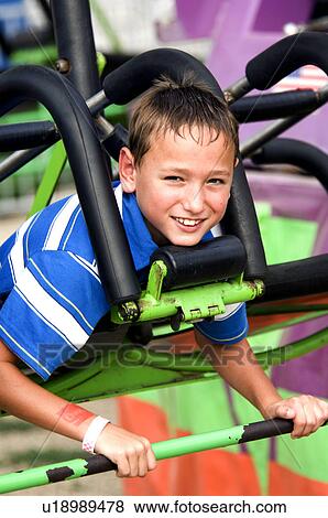 Kid on a carnival ride View Large Photo Image Stock Photo - Kid on a carnival ride. Fotosearch