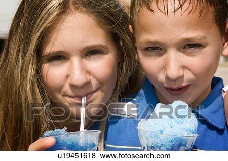Stock Photo - Kids eating carnival food. Fotosearch