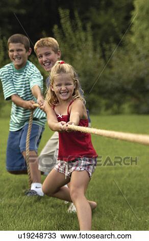 Stock Image - Kids playing tug of war. Fotosearch