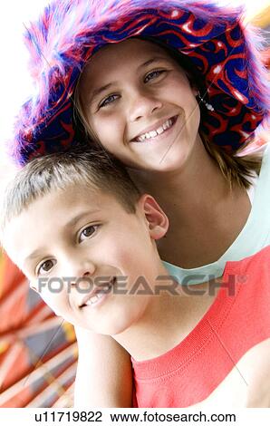 Stock Image - Kids wearing funky carnival hat. Fotosearch