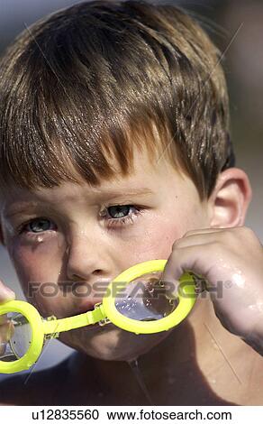 Little boy taking off swimming goggles View Large Photo Image Stock Image - Little boy taking off swimming goggles. Fotosearch