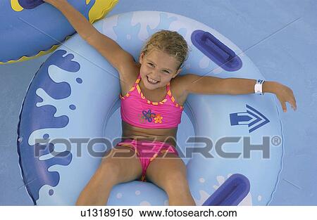 Little girl in a pool View Large Photo Image Stock Image - Little girl in a pool. Fotosearch