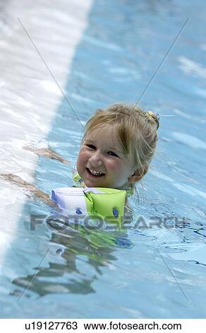 Little girl in a pool View Large Photo Image Stock Image - Little girl in a pool. Fotosearch