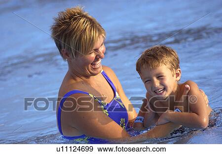 Woman helping boy to swim View Large Photo Image Stock Photo - Woman helping boy to swim. Fotosearch