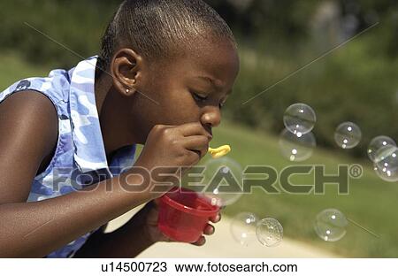 Young girl blowing bubbles View Large Photo Image Stock Image - Young girl blowing bubbles. Fotosearch