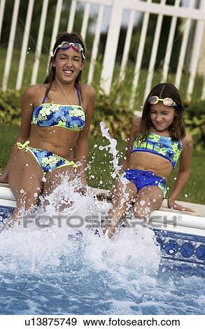 Stock Photo - Young girls in pool. Fotosearch