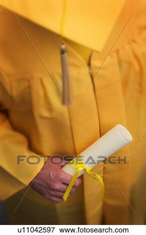Stock Photo - Graduate holding diploma. Fotosearch