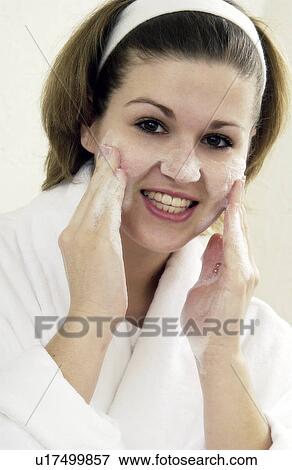 Stock Photo - Woman cleansing her face. Fotosearch
