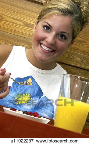 Woman having breakfast in bed View Large Photo Image Stock Photo - Woman having breakfast in bed. Fotosearch
