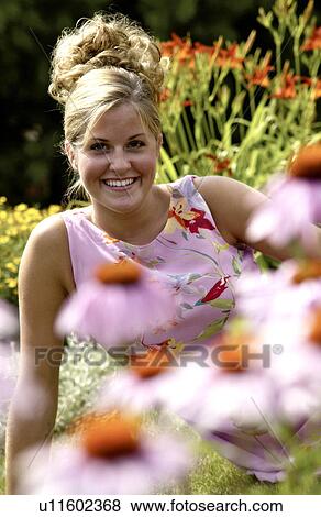 Woman in field of flowers View Large Photo Image Stock Photo - Woman in field of flowers. Fotosearch