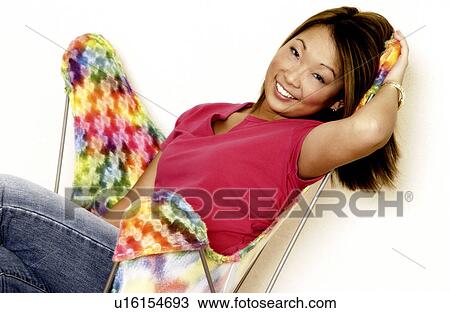 Woman relaxing in chair View Large Photo Image Stock Image - Woman relaxing in chair. Fotosearch