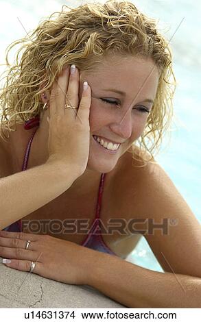 Picture - Woman standing in a pool. Fotosearch