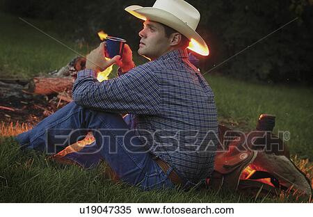 Stock Photography - Cowboy near campfire. Fotosearch