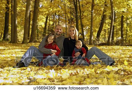 Family in autumn background View Large Photo Image Stock Photo - Family in autumn background. Fotosearch