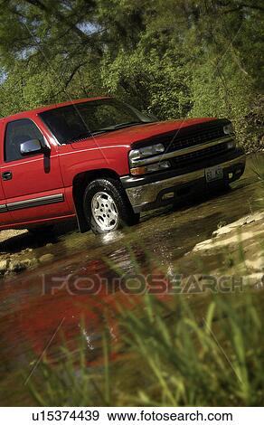Stock Photo - Truck driving across creek. Fotosearch
