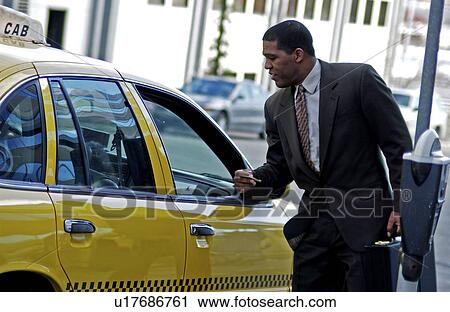 Businessman getting into cab View Large Photo Image Stock Image - Businessman getting into cab . Fotosearch