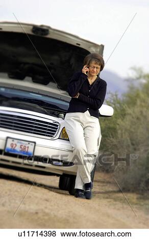 Stock Photo - Woman with broken down car. Fotosearch