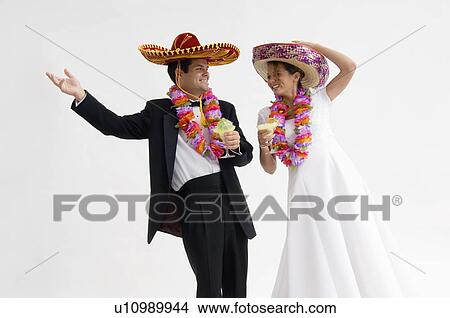 Bride and groom wearing sombreros and leis and holding margarita View Large Photo Image Picture - Bride and groom wearing sombreros and leis and holding margarita. Fotosearch