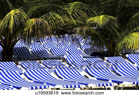 Stock Photo - Lounge chairs on beach. Fotosearch