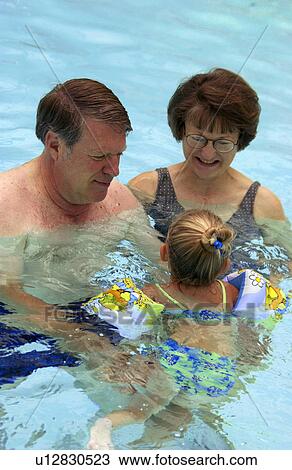 Senior couple swimming with toddler View Large Photo Image Stock Image - Senior couple swimming with toddler. Fotosearch