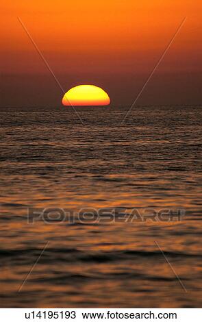 Sunset over the ocean View Large Photo Image Stock Image - Sunset over the ocean. Fotosearch