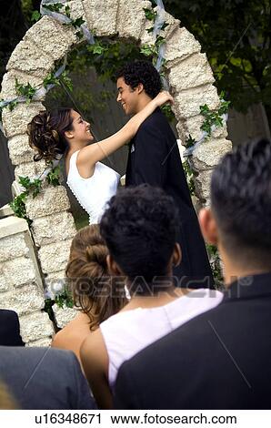 Stock Image - Bride and Groom at altar. Fotosearch