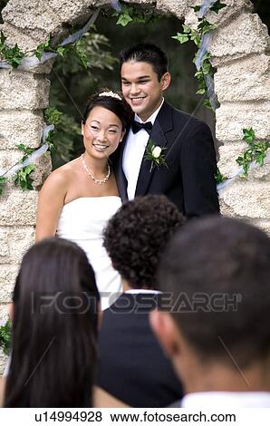 Stock Photo - Bride and Groom at altar. Fotosearch
