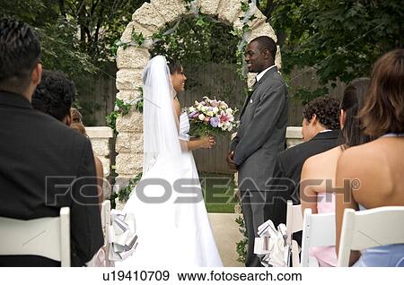 Stock Photo - Bride and Groom at altar. Fotosearch
