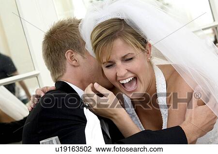 Stock Image - Bride and groom laughing. Fotosearch