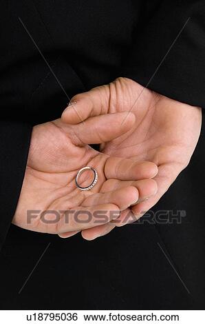 Groom holding hands behind back View Large Photo Image Stock Photograph - Groom holding hands behind back. Fotosearch