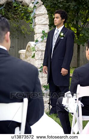 Stock Image - Groom waiting at altar. Fotosearch
