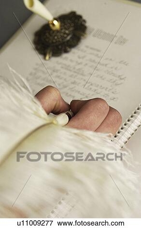 Woman signing wedding guest book View Large Photo Image Stock Photo - Woman signing wedding guest book. Fotosearch