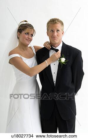 Picture - Bride fixing groom's bow tie. Fotosearch